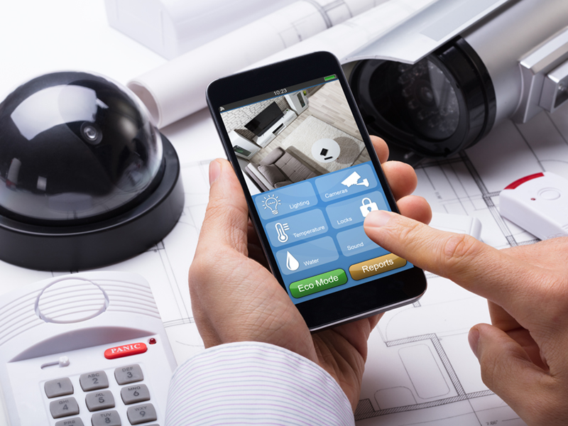 Person Hand Using Home Security System On Mobilephone